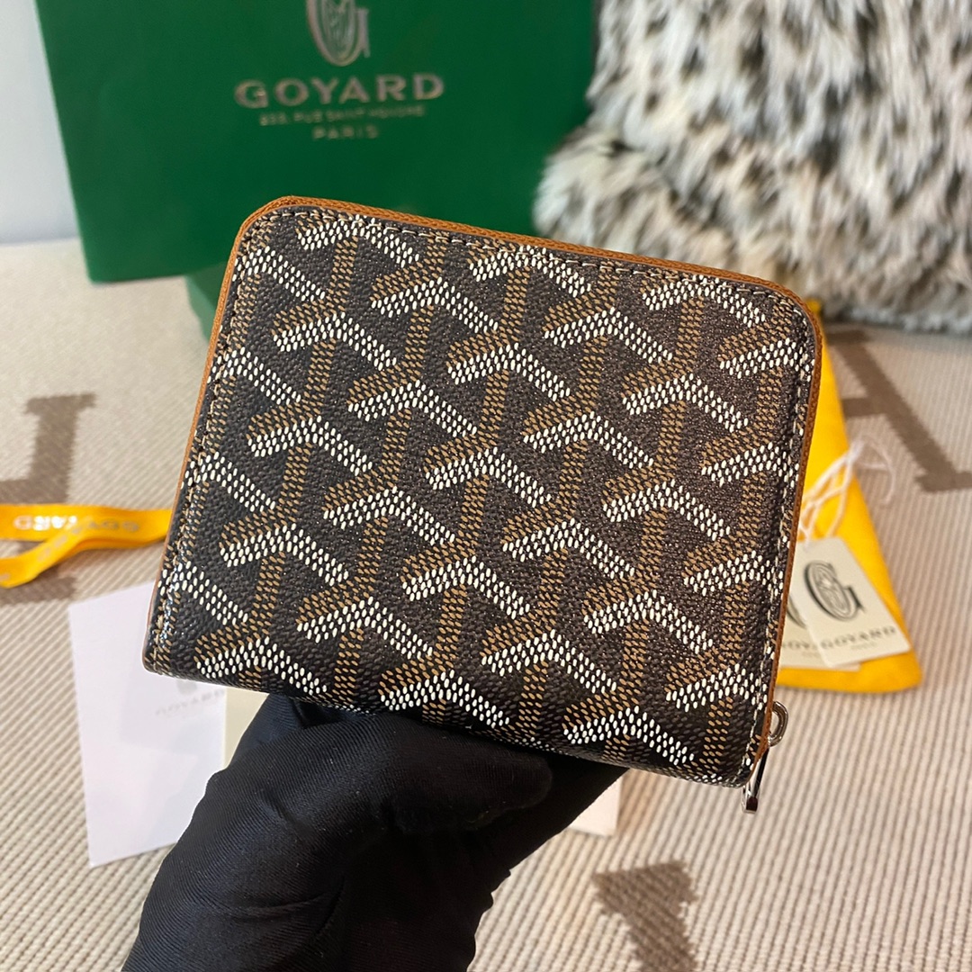 Black and tan Goyard Matignon PM Wallet is a compact shape and closes securely with a zip