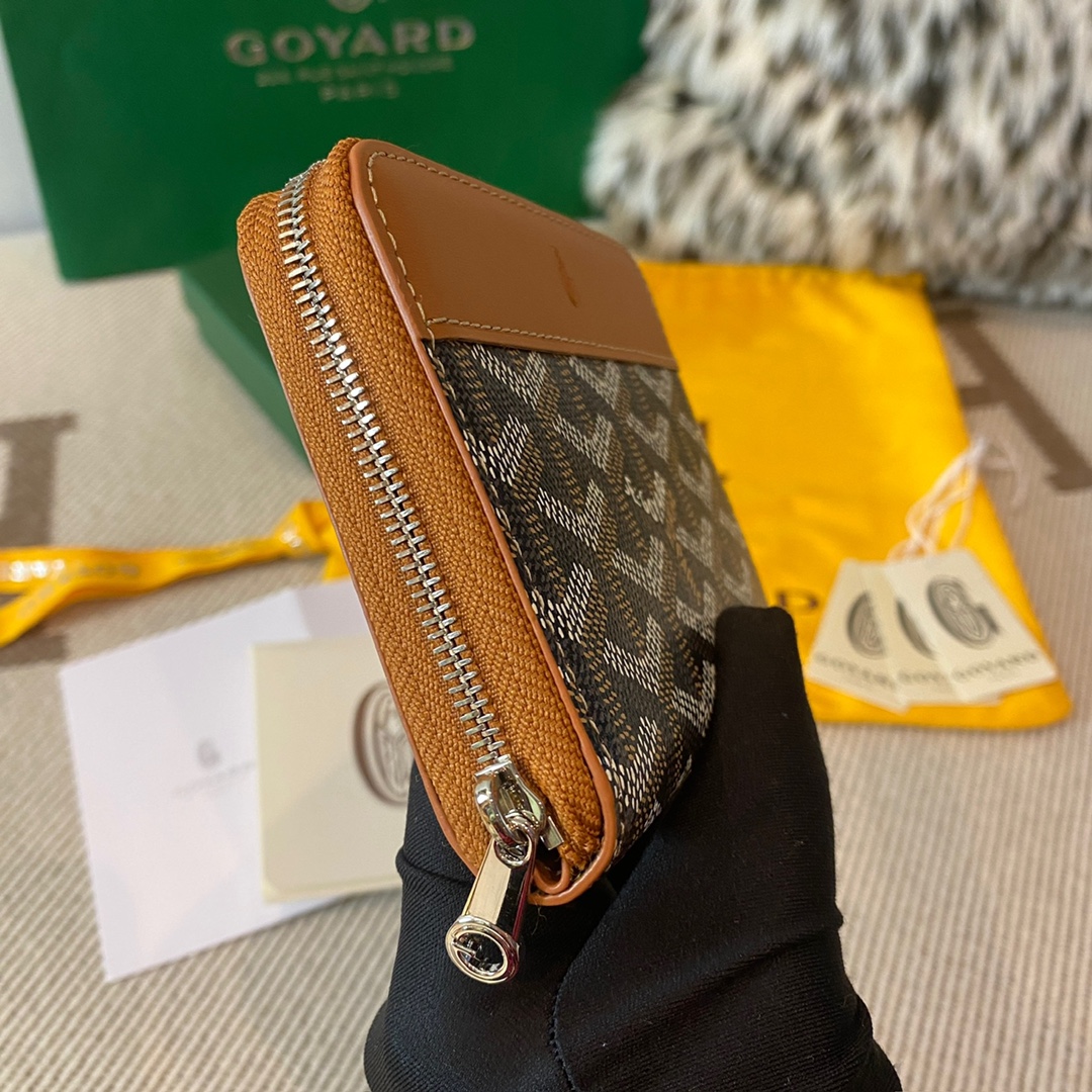 Black and tan Goyard Matignon PM Wallet is a compact shape and closes securely with a zip