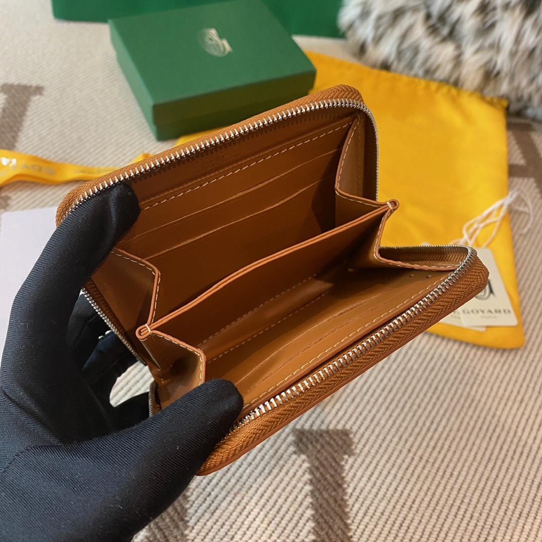 Black and tan Goyard Matignon PM Wallet is a compact shape and closes securely with a zip