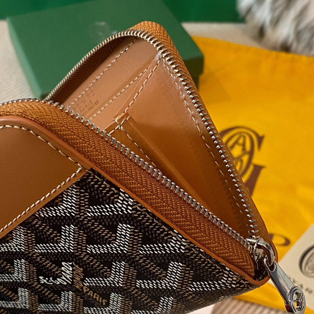 Black and tan Goyard Matignon PM Wallet is a compact shape and closes securely with a zip