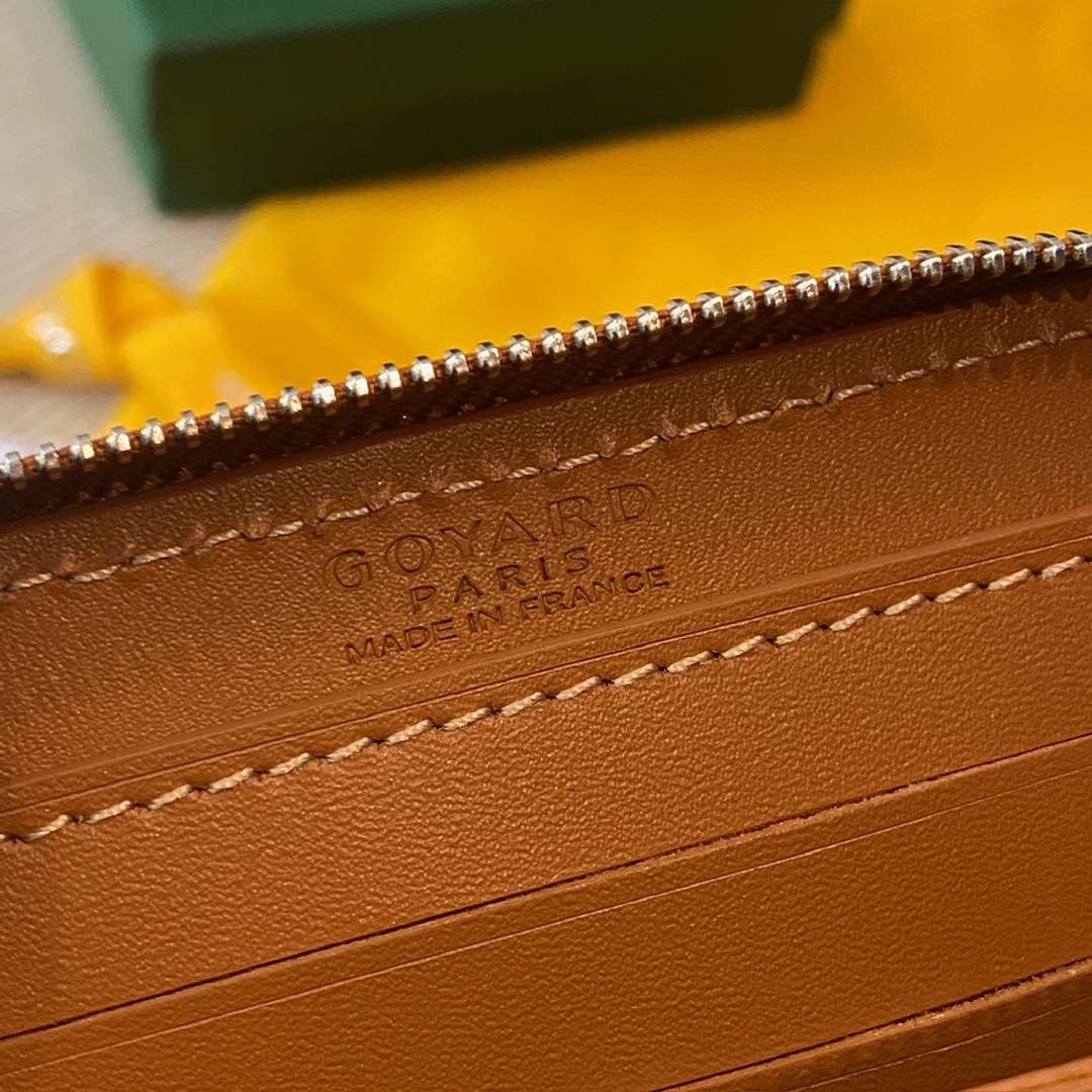 Black and tan Goyard Matignon PM Wallet is a compact shape and closes securely with a zip